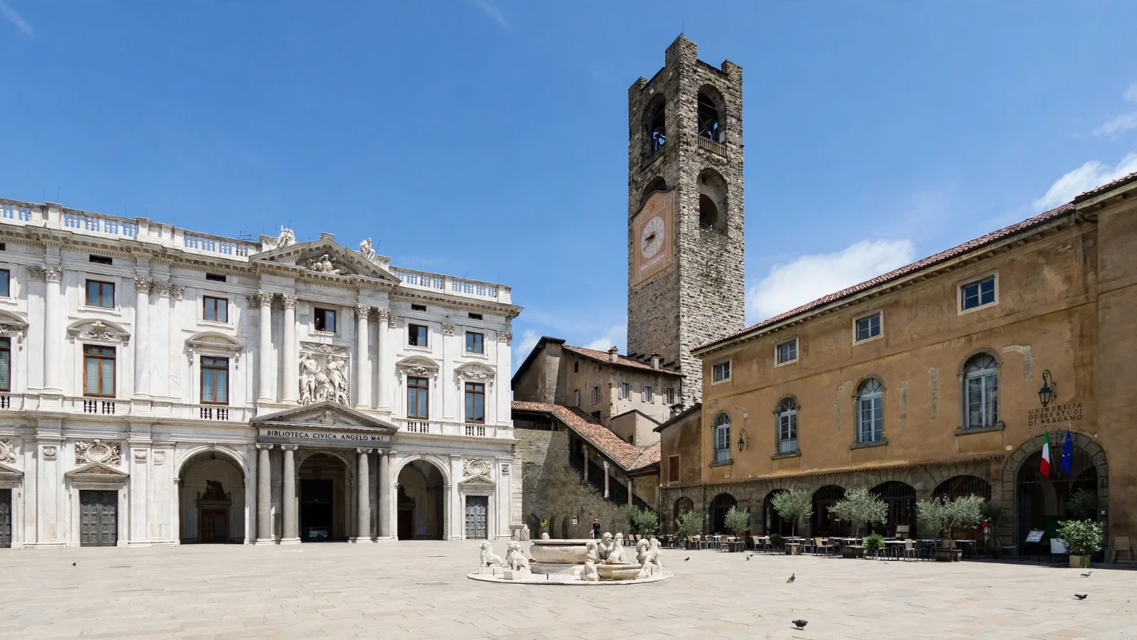 Piazza Vecchia in Bergamo Città Alta showing the white marble facade of Palazzo Nuovo, the tall stone Campanone bell tower, and the Contarini fountain on flat stone paving