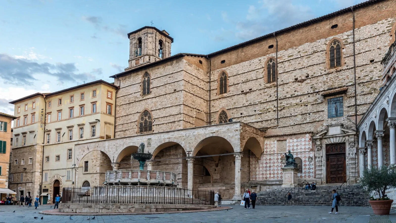 Side arcade and unfinished stone wall of the Cathedral of San Lorenzo facing Piazza IV Novembre in Perugia