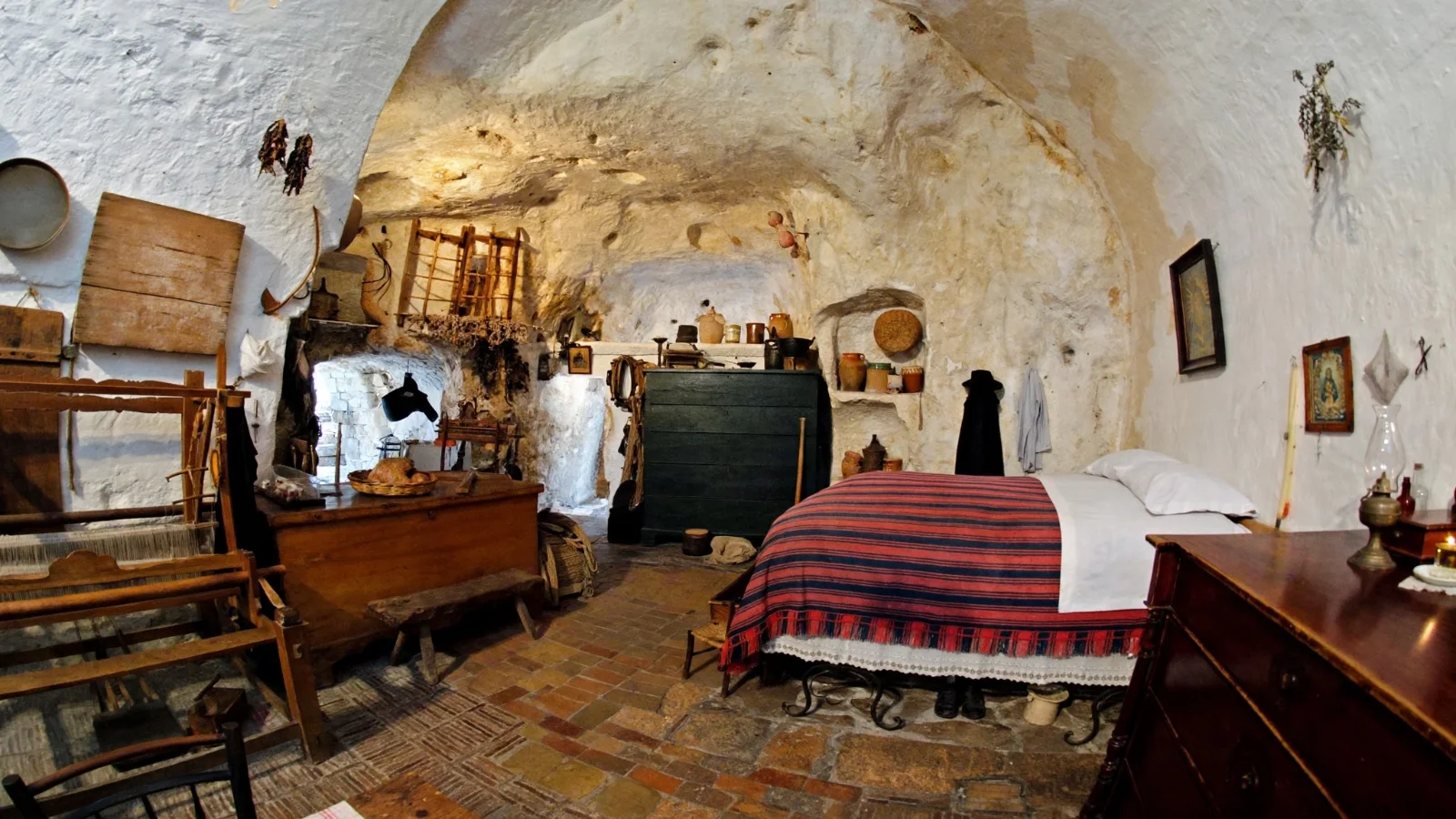 Stone staircase leading down into the courtyard of Casa Grotta di Vico Solitario in Sasso Caveoso, Matera